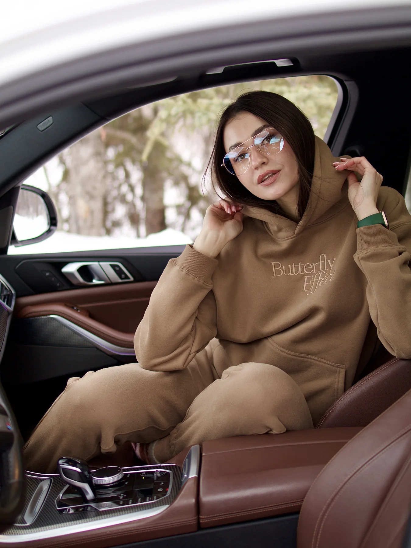 Fashion lifestyle portrait of Olesia seated in a car